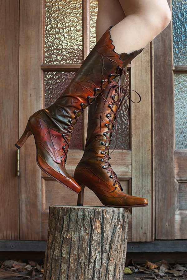 Embossed leather high leaf boots featuring intricate patterns, combining style and texture